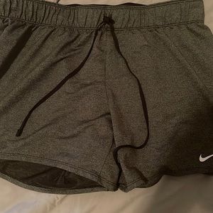 Black and grey nike shorts .